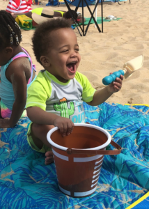Deuce playing in the sand at Rehoboth Beach - Tips for taking your baby to the beach