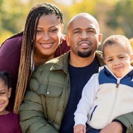 Harrison family posing in a photo shoot planned by Tiffany Harrison Motherhood Blogger