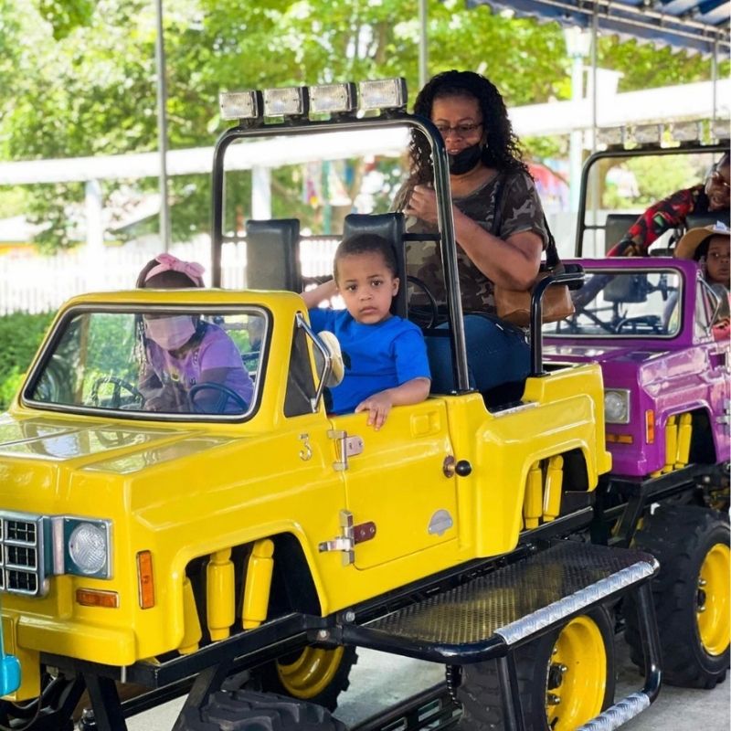 Deuce driving a yellow truck on the off-road rally ride at Dutch Wonderland