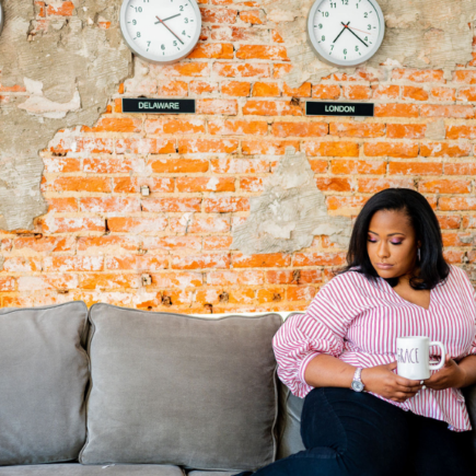 Tiffany Harrison, lead blogger from Tiffanydoesitall.com holding a coffee mug.