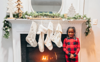 Annalise standing in front of my Christmas Mantel