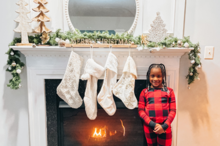 Annalise standing in front of my Christmas Mantel