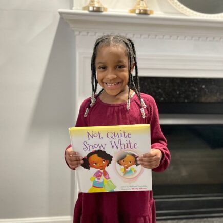 Fairy Tales with Black Characters feature image - Annalise holding the book not quite snow white