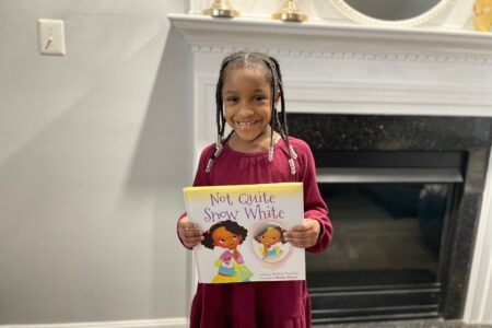 Fairy Tales with Black Characters feature image - Annalise holding the book not quite snow white