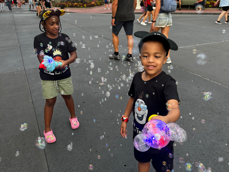 Annalise and Deuce enjoying their bubble wands. Get yours at the link below for less than half the price in the parks.