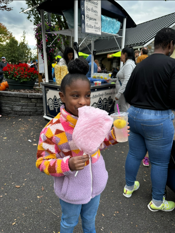 Annalise enjoying cotton candy and lemonade.