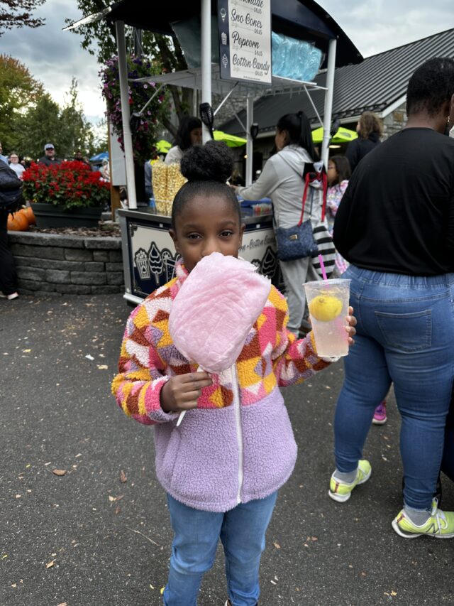 Annalise eating cotton candy and lemonade at Hersheypark.